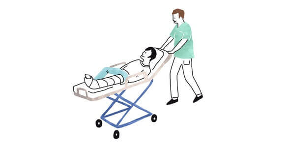 A doctor pushing a patient on a hospital bed